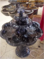 A beautifully crafted black marble fountain from Erfoud, Morocco, featuring fossilized orthoceras, showcasing intricate fossil details and elegant design.