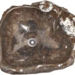 An elegant fossilized marble sink from Erfoud, Morocco, featuring natural stone patterns and rich coloration, highlighting expert stonework.